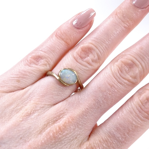 468 - A 9ct gold opal dress ring, crossover style settings, setting height 9.5mm, size Q, 3g