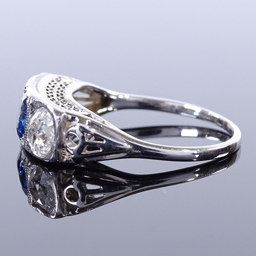 470 - An unmarked platinum 3-stone sapphire and diamond half-hoop panel ring, pierced shoulders and bridge... 