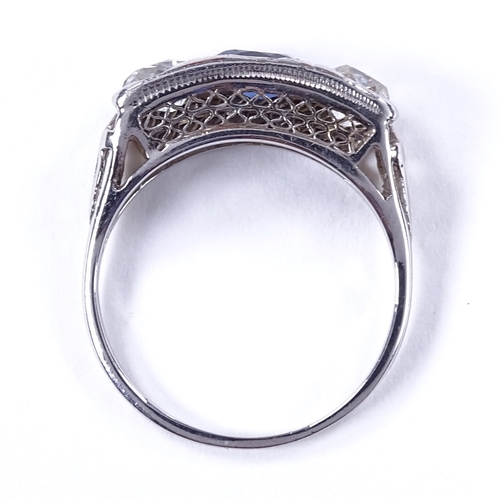 470 - An unmarked platinum 3-stone sapphire and diamond half-hoop panel ring, pierced shoulders and bridge... 