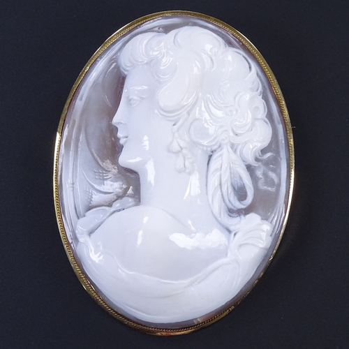 475 - A large relief carved cameo shell panel pendant/brooch, depicting female bust, in 18ct rope twist fr... 