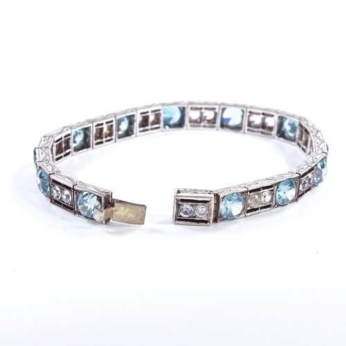 480 - An Art Deco unmarked silver blue topaz and white sapphire line panel bracelet, openwork settings wit... 