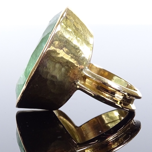 484 - A large handmade 18ct gold solitaire emerald dress ring, oval-cut emerald approx 50ct, in planished ... 