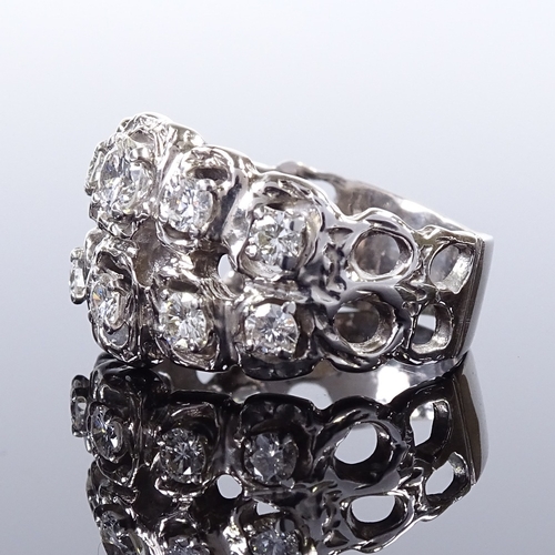 497 - A 14ct white gold diamond cluster abstract ring, openwork settings and shoulders, largest diamond ap... 