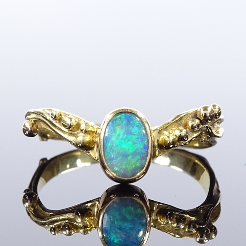 499 - An unmarked gold opal wishbone ring, relief berry shoulders, setting height 8.2mm, size T, 3.5g