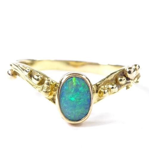 499 - An unmarked gold opal wishbone ring, relief berry shoulders, setting height 8.2mm, size T, 3.5g