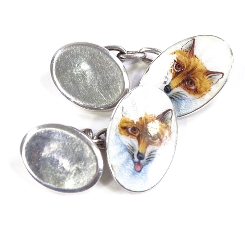 512 - A pair of Continental silver and enamel hunting fox head oval cufflinks, panel length 18.8mm, 6.5g