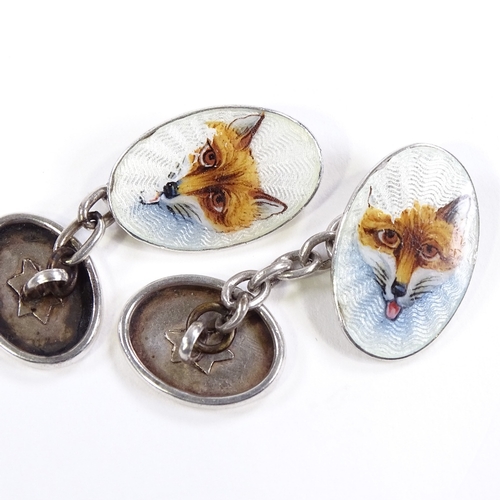 512 - A pair of Continental silver and enamel hunting fox head oval cufflinks, panel length 18.8mm, 6.5g