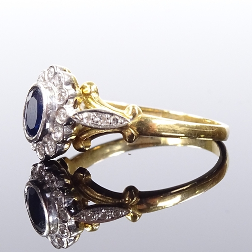 514 - An 18ct gold sapphire and diamond cluster ring, with diamond set foliate shoulders, setting height 1... 