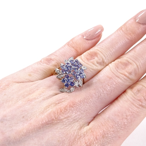 515 - A 9ct gold blue stone and diamond cluster cocktail ring, with openwork bridge, setting height 22.3mm... 