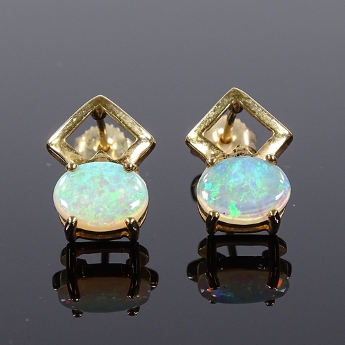 516 - A pair of 9ct gold opal earrings, stud fittings with openwork settings, height excluding fitting 13.... 