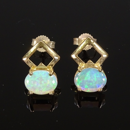 516 - A pair of 9ct gold opal earrings, stud fittings with openwork settings, height excluding fitting 13.... 