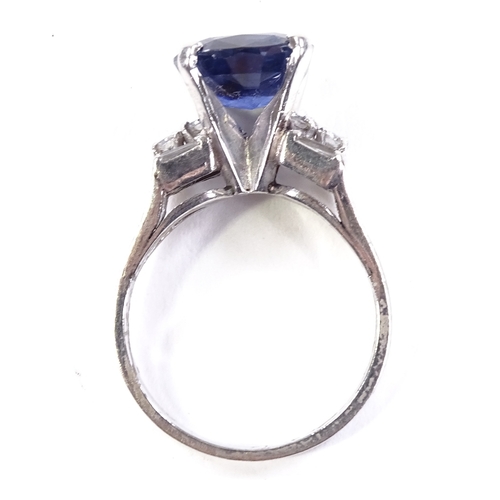 518 - A platinum sapphire and diamond dress ring, set with cushion-cut sapphire and baguette and round-cut... 