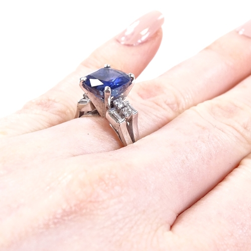 518 - A platinum sapphire and diamond dress ring, set with cushion-cut sapphire and baguette and round-cut... 