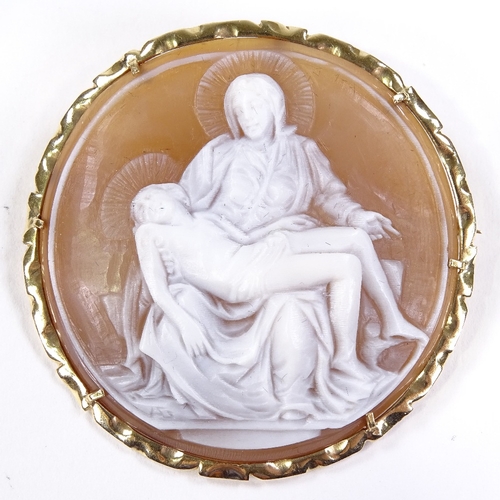 535 - A relief carved circular cameo shell panel pendant/brooch, depicting Madonna and Christ, 14ct frame,... 