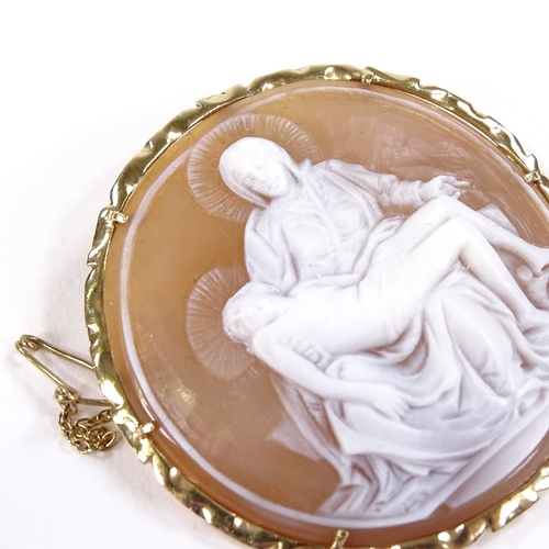 535 - A relief carved circular cameo shell panel pendant/brooch, depicting Madonna and Christ, 14ct frame,... 