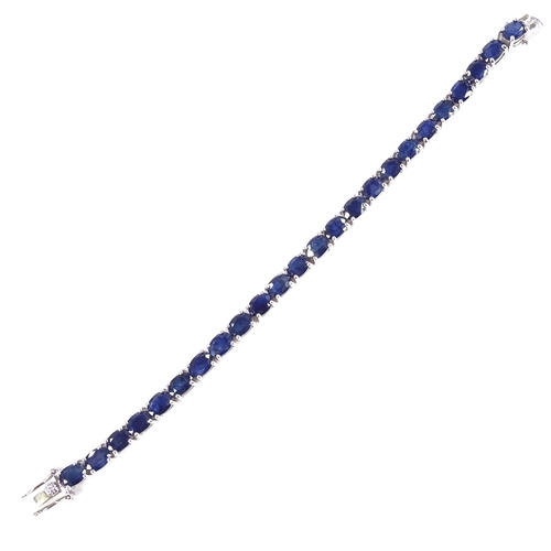 538 - A sterling silver sapphire line bracelet, total oval-cut sapphire content approx 19ct, bracelet leng... 