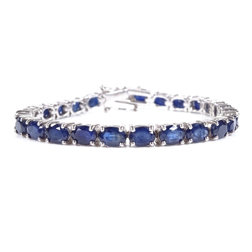 538 - A sterling silver sapphire line bracelet, total oval-cut sapphire content approx 19ct, bracelet leng... 