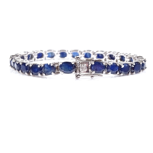 538 - A sterling silver sapphire line bracelet, total oval-cut sapphire content approx 19ct, bracelet leng... 