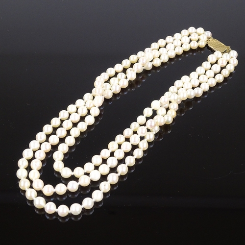 541 - A triple strand cultured pearl collar necklace, on 9ct foliate engraved clasp, necklace length 13