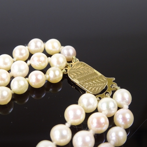 541 - A triple strand cultured pearl collar necklace, on 9ct foliate engraved clasp, necklace length 13