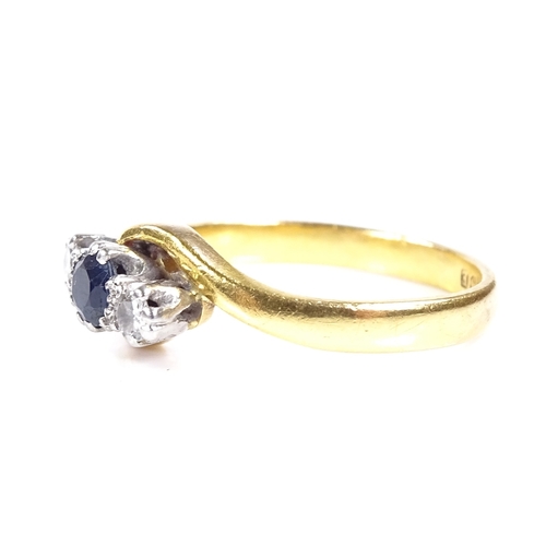 557 - A 22ct gold 3-stone sapphire and diamond crossover ring, platinum-topped settings, hallmarks Birming... 