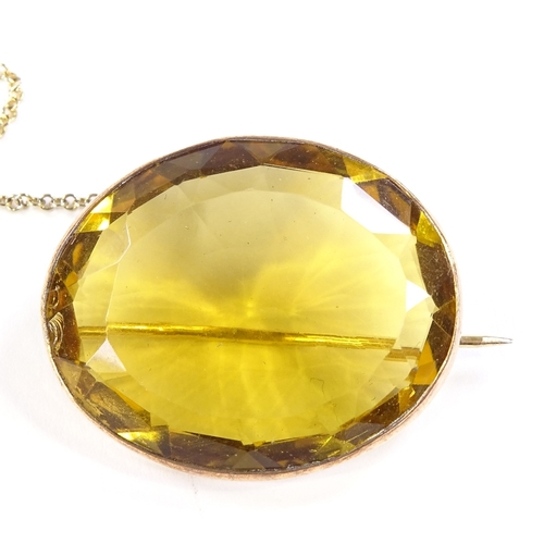 564 - An unmarked gold oval-cut citrine brooch, brooch length 32.4mm, 11.4g