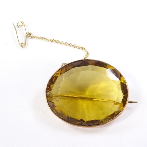 564 - An unmarked gold oval-cut citrine brooch, brooch length 32.4mm, 11.4g