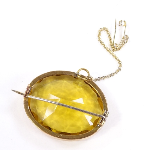 564 - An unmarked gold oval-cut citrine brooch, brooch length 32.4mm, 11.4g