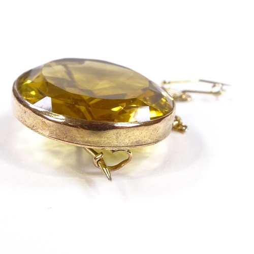 564 - An unmarked gold oval-cut citrine brooch, brooch length 32.4mm, 11.4g