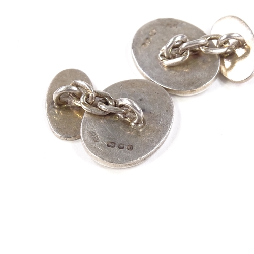 566 - A pair of silver oval cufflinks, by Mappin & Webb Ltd, hallmarks London 1978, panel length 18.5mm, 1... 