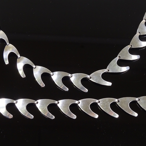 575 - A Carl Ove Frydensberg Danish sterling silver matching necklace and bracelet, of plain boomerang for... 