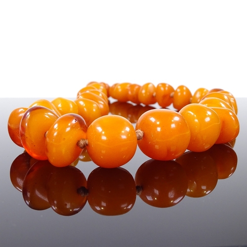 579 - A simulated butterscotch amber single strand necklace, largest bead length 18.6mm, necklace length 5... 