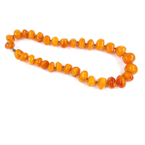 579 - A simulated butterscotch amber single strand necklace, largest bead length 18.6mm, necklace length 5... 