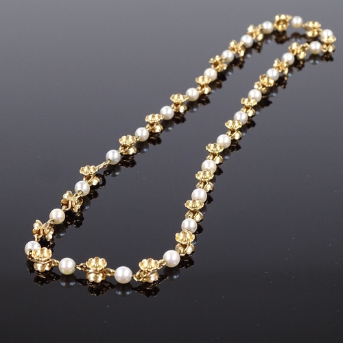 581 - A 14ct gold pearl floral necklace, necklace length 40cm, 15.9g, and an 8ct gold garnet half hoop rin... 