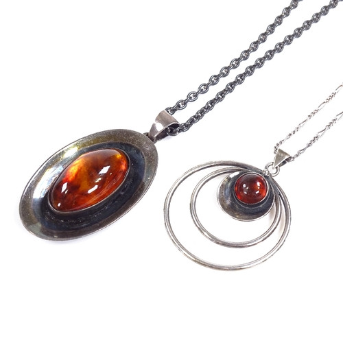 584 - 2 N.E. From Danish sterling silver and amber pendant necklaces, stylised form, circular pendant diam... 