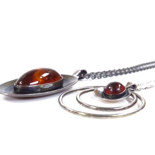 584 - 2 N.E. From Danish sterling silver and amber pendant necklaces, stylised form, circular pendant diam... 