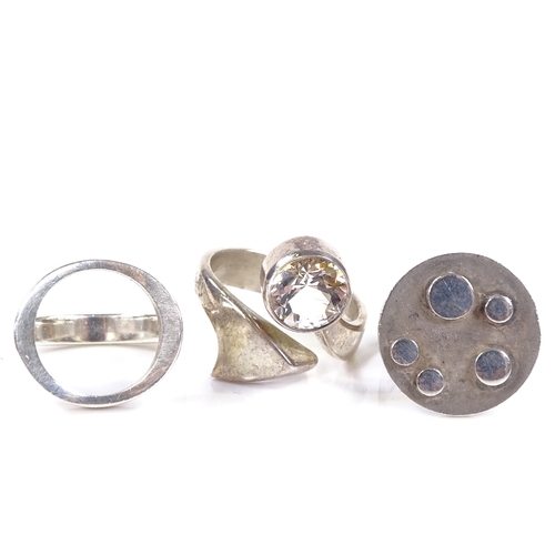 593 - 2 N.E. From Danish sterling silver rings, and a similar circular abstract panel ring, panel diameter... 