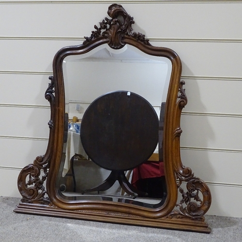 304 - A carved and shaped walnut-framed over mantel mirror, circa 1900, height 3'11