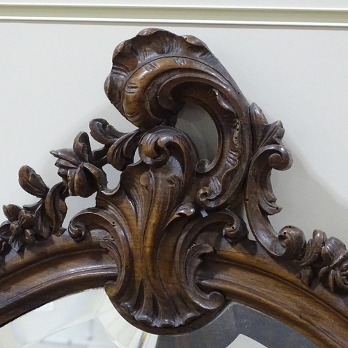 304 - A carved and shaped walnut-framed over mantel mirror, circa 1900, height 3'11