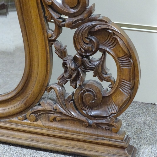 304 - A carved and shaped walnut-framed over mantel mirror, circa 1900, height 3'11