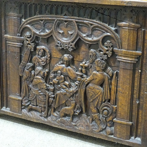 305 - An Antique carved and panelled Gothic style hall settle, with relief carved tracery panelled back, w... 