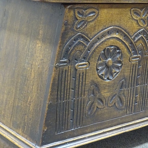 307 - A good quality reproduction carved oak coffer of plank construction, width 2'11