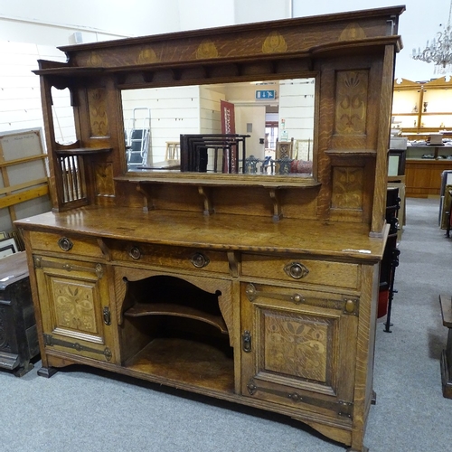 308 - A good quality Arts and Crafts oak sideboard, by Shapland & Petter, with mirror inset back, stylised... 