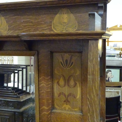 308 - A good quality Arts and Crafts oak sideboard, by Shapland & Petter, with mirror inset back, stylised... 