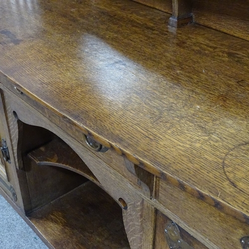 308 - A good quality Arts and Crafts oak sideboard, by Shapland & Petter, with mirror inset back, stylised... 