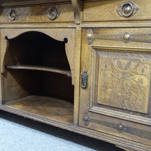 308 - A good quality Arts and Crafts oak sideboard, by Shapland & Petter, with mirror inset back, stylised... 