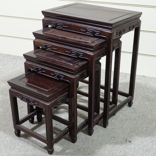 312 - A nest of Chinese hardwood occasional tables with carved friezes, largest table 20