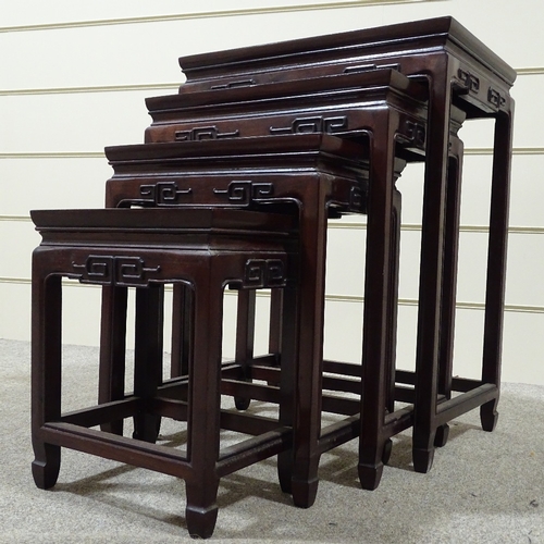 312 - A nest of Chinese hardwood occasional tables with carved friezes, largest table 20