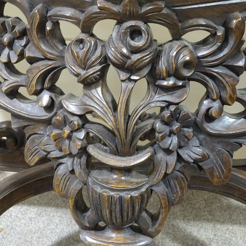 313 - An ornate Rococo style carved walnut console table with shaped marble top, carved and pierced floral... 