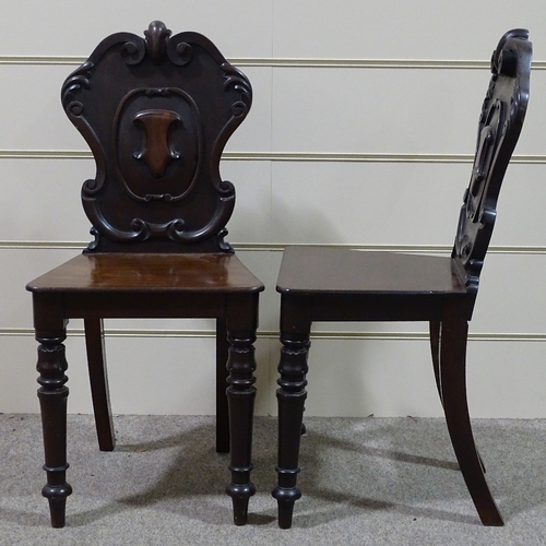 315 - A pair of Victorian mahogany hall chairs with shield-shaped backs